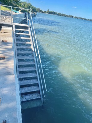 Walk down the steps into the clear, calming lake