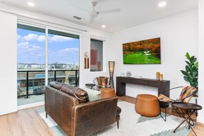 Living room area with views of nearby shops