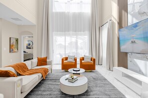 luxury living room with burnt orange accent and 75 inches UHD TV