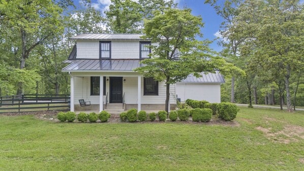 A gorgeous 4 bedroom farmhouse nestled in 5+ acres of nature