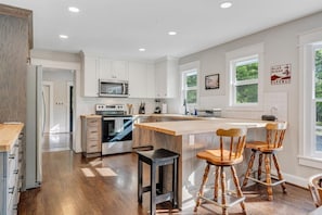 Butcher block counter tops and breakfast bar with seating for 3