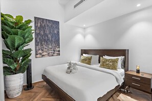 Serene Bedroom Retreat: Unwind in style with plush pillows and artistic flair all around!