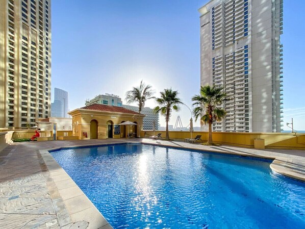 Sunny Oasis: Dive into relaxation by the sparkling pool with stunning skyline views!