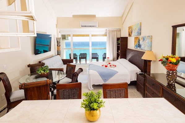 Downstairs living/sleeping area with balcony overlooking the beach. 