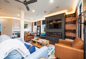 [Fireplace] Cozy Living Room with a Gas Fireplace and an Abundance of Lighting