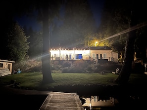Nighttime view from dock looking back at house. 