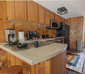The kitchen features stainless steel appliances and a Keurig coffee maker.
