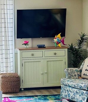 The living room is equipped with a 50-inch smart TV including cable.