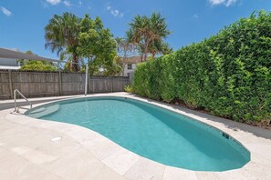 Step through your private garage and emerge beside the secluded communal pool