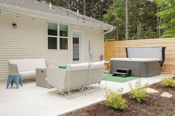 Inviting patio with hot tub in the woods
