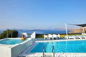 Private swimming pool with sun loungers and a breathtaking sea view