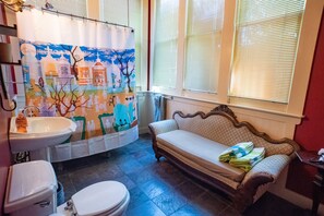 Spacious bathroom with combination clawfoot tub/shower