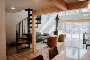 Living room with a wood burning fireplace and comfortable seating