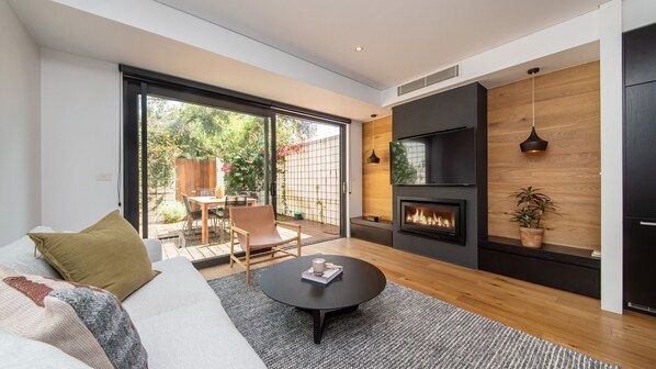 Stunning living space with gas fireplace, smart tv and leading to courtyard 