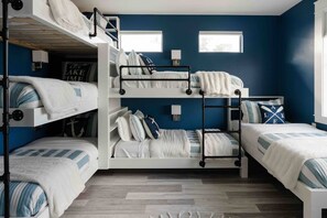 This room is going to make the kids smile!  Who is going to get the top bunk or the one that feels like a hidden cave?  There are 4 XL twins and 2 regular twins in this room (so those tall teens of yours can be comfy too).