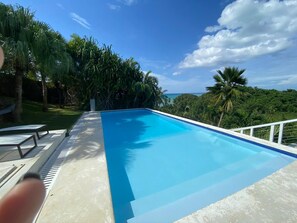 Swimming pool has shallow area for children to play and dinner for diving