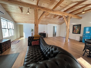 Tufted sofa facing the fireplace.