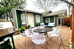 Patio area with dining table, patio seating and grill