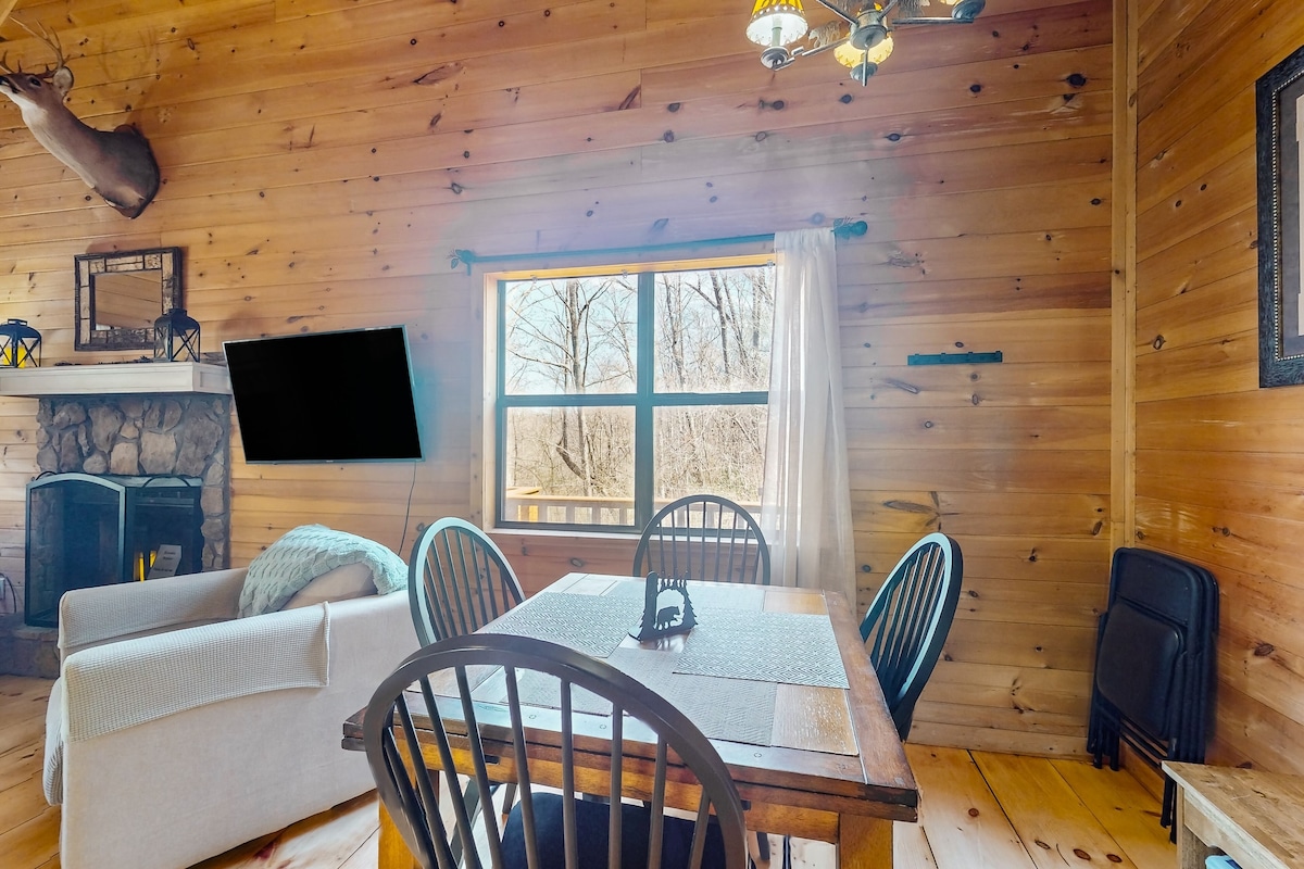 Rustic creek-front cabin with private hot tub, game room, water views, & firepit