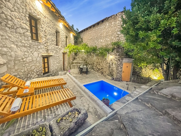 Pool with sun loungers. 