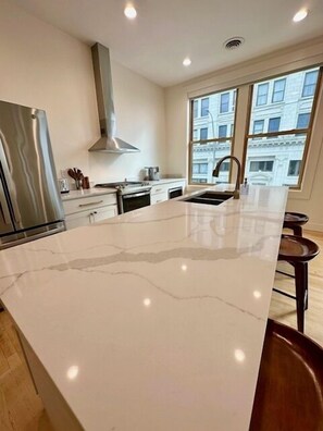 Island equipped with sink, and dishwasher!