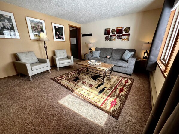 Unit 1 Living Room includes queen size sofa sleeper and 2 arm chairs.