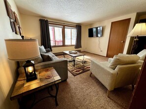 Unit 1 Living Room has a wonderful view outdoors and a Smart TV to watch your favorite streaming channels.