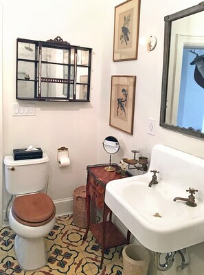Antiques and original artwork in the bathroom.