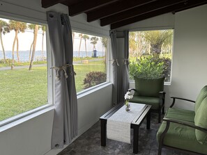 Front screened in patio with direct water view. 