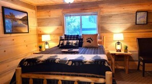 Master bedroom with log style queen bed and night stands.