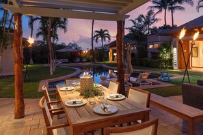 Delightful meals await under the pergola as you watch friends and family swim.