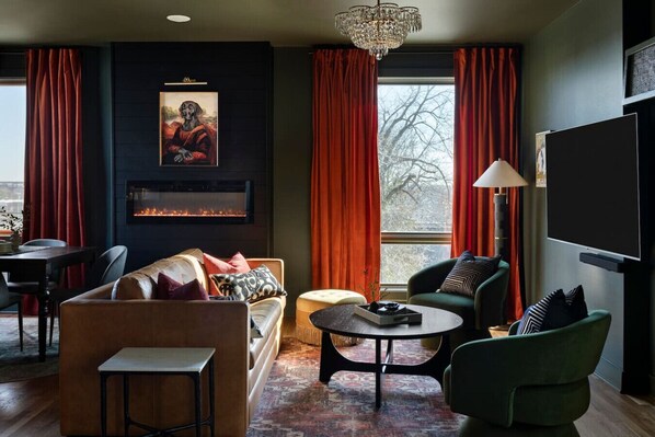 Cozy lounge with fireplace and smart TV.