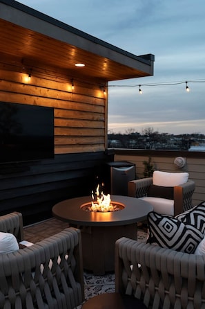 Rooftop views with a warm fire.