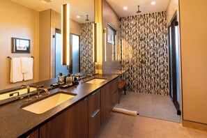 Roll-in shower that also leads to an outdoor shower amenity. Double sink for ease of use and separate water closet