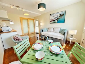 Bright studio with a sofa bed, dining area, and kitchenette. Ideal for a cosy and comfortable stay.