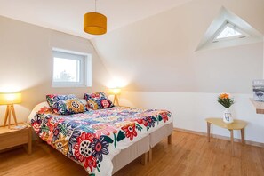 Restful bedroom with a double bed and plush bedding, offering peaceful sea views to wake up to.