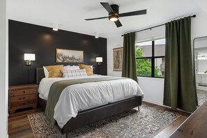 Main bedroom w/king size bed, blackout curtains & direct access to the balcony.