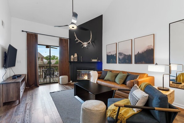 Cozy modern transitional living room with electric fireplace, 55" smart TV.