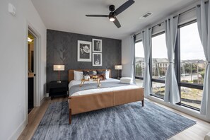 Unit 1: Primary Bedroom with King bed, smart TV, large walk-in closet, and en-suite bathroom.