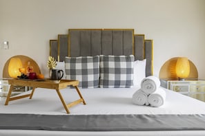 This is the master bedroom (King-size bed), ensuite bathroom. Find comfort and serenity in our luxurious bedrooms equipped with AC and a cozy king-size bed.