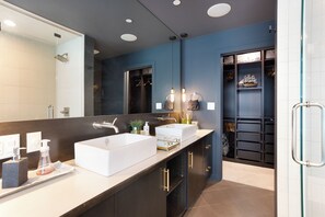 Private ensuite with overhead shower, walk-in closet, dual vanity & amenities.