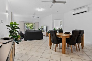 Chill in style in our Cozy 3-Bedroom Oasis, where the inviting living room with a dining table sets the perfect space for relaxation and meals, plus exclusive pool access to complete your Cairns getaway