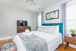 Relax in style in the secondary bedroom, complete with a cozy queen bed and a full en suite bathroom, plus a flat-screen TV with Roku for unwinding after a long day.