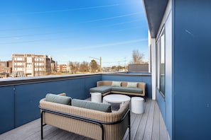 Private outdoor patio with comfortable lounge seating.