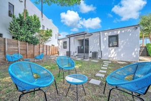 Guests of both units in the duplex can enjoy the shared backyard, a serene retreat ideal for both leisurely afternoons and enjoying a peaceful cup of morning coffee.