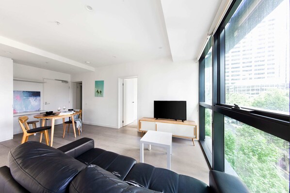 A modern living area with a 3-seater couch.