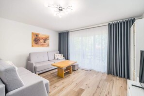 Another angle of the living room, showcasing a comfortable seating area and a well-lit, modern interior.