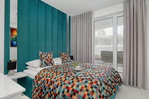 A stylish bedroom featuring a turquoise accent wall, a patterned bedspread, and floor-to-ceiling windows.

