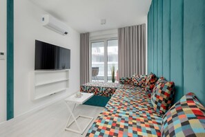 Another view of the bedroom, highlighting a built-in TV, modern decor, and a comfortable sleeping area.

