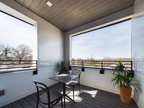 Unit 2: Private balcony with outdoor seating and refreshing Downtown views.